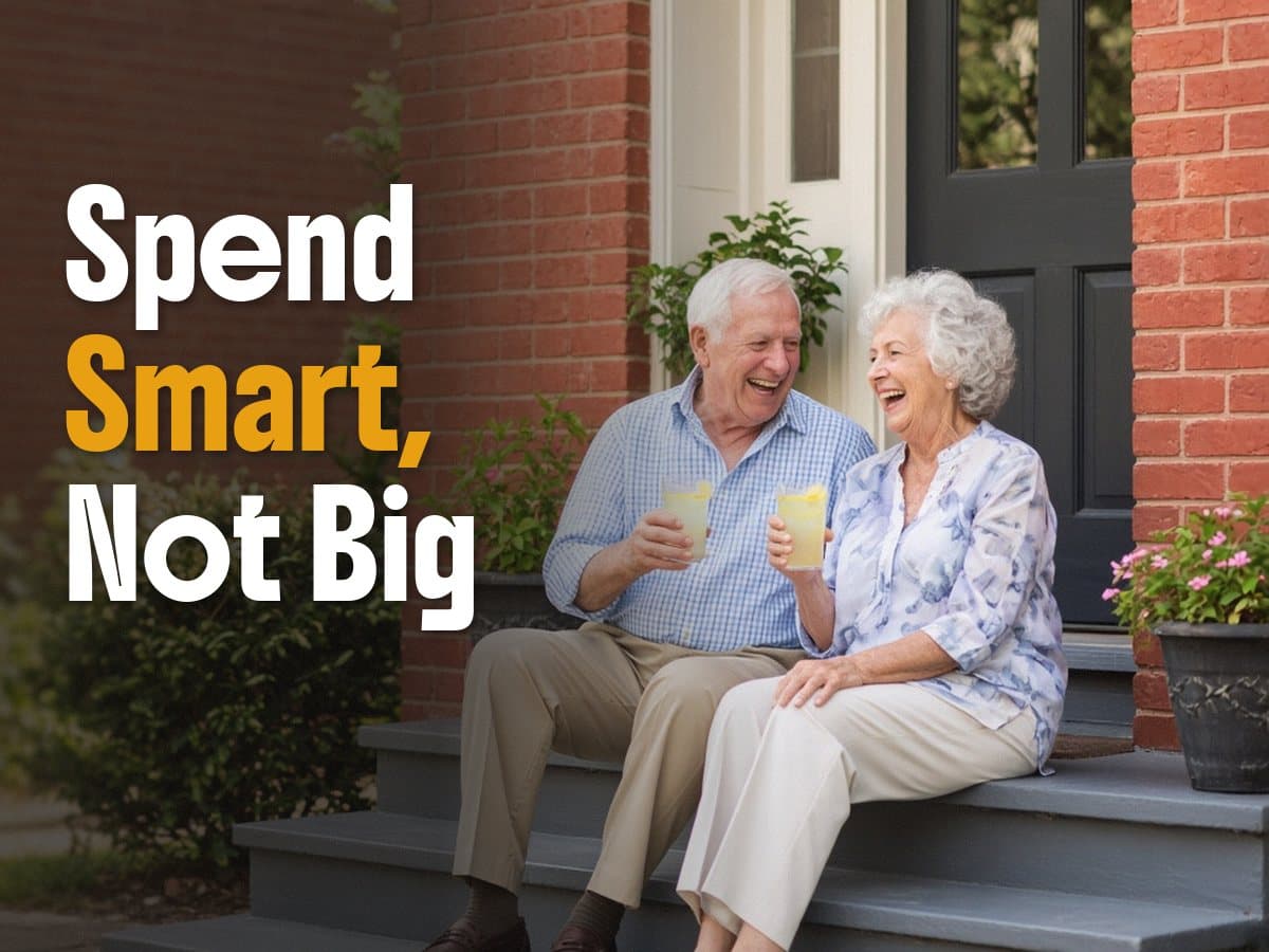 An older couple laughs on a brick porch holding lemonade, beside the words Spend Smart, Not Big.